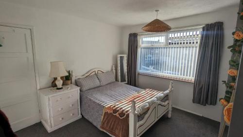 a small bedroom with a bed and a window at Stay your way in Huyton with Roby
