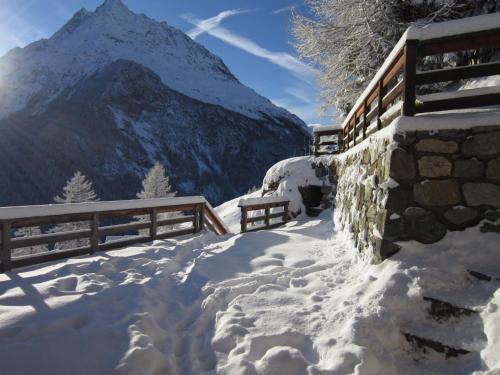 a mountain covered in snow with a fence at Mayen Farquesses in Evolène