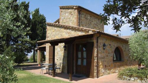 a stone building with a table in front of it at Agriturismo Casale trieste in Laiatico