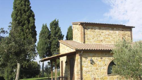 a stone building with a tower on top of it at Agriturismo Casale trieste in Laiatico