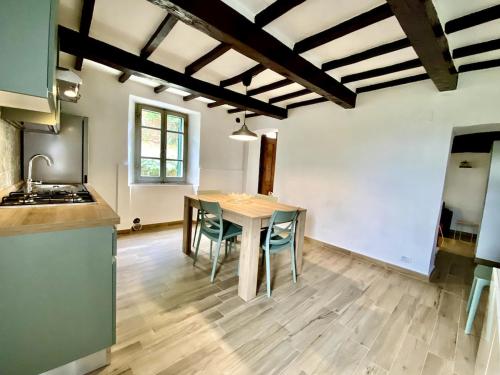 a kitchen and dining room with a table and chairs at Saturnia Siria Holiday in Poggio Murella