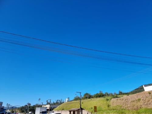 a blue sky over a hill with power lines at Ape da Deisi Termas in Gravatal