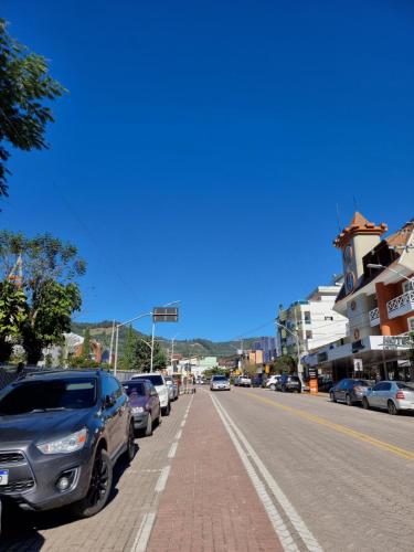 a city street with cars parked on the side of the road at Ape da Deisi Termas in Gravatal