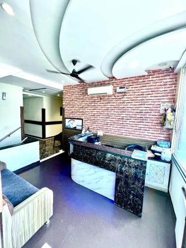a bathroom with a sink and a brick wall at Hotel Woodcrest by Sidham Group !! Comfortable and Peaceful Stay !! Top Rated !! Preferred Hotel Chain in Chandīgarh