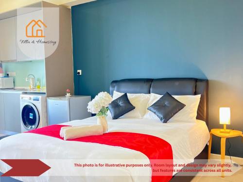 a bedroom with a large bed with a blue wall at The Executive Lofts - Cyber City Suites in Cyberjaya