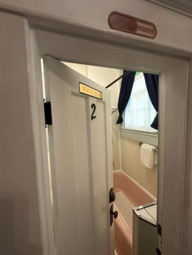 a bathroom with a door with a sign on it at Belmont Inn in Shelbyville