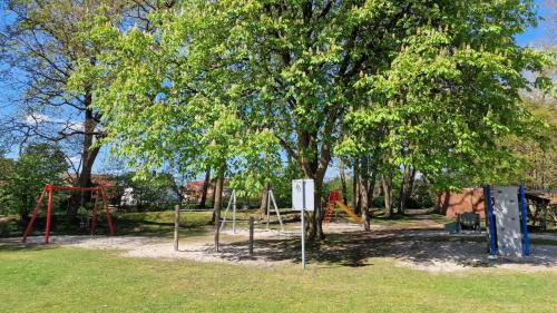 a park with a swing set and trees at EcoCube 141 - Terrasse, 3Zimmer, Waschmaschine, Backofen, 5Pers in Meppen