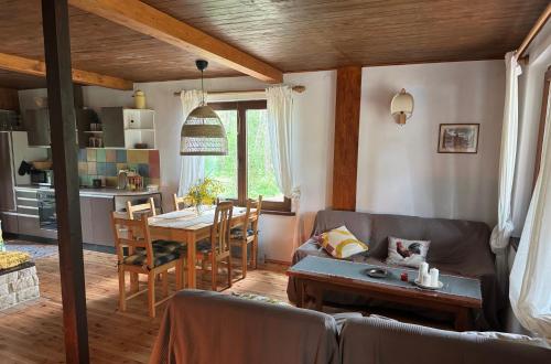 a living room with a couch and a table at Chatka Poddębie in Poddębie