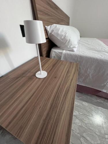 a table with a lamp on it next to a bed at Casa Vacanza Cupello in Cupello