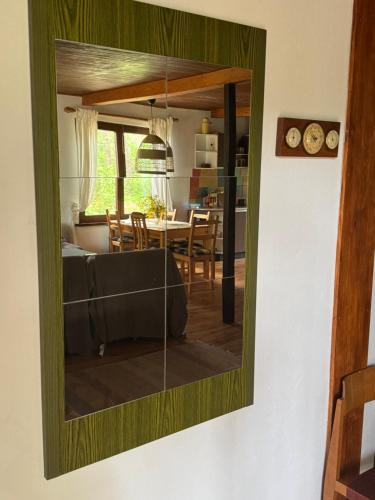 a mirror hanging on a wall in a living room at Chatka Poddębie in Poddębie