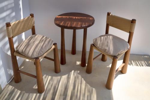 a table and two chairs and a small table at Petradi Studios & Villa in Aegiali