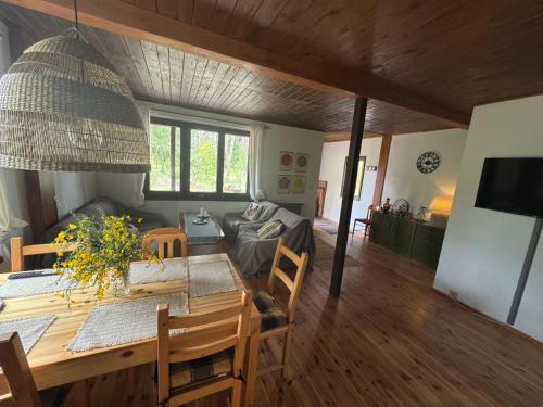 a dining room and living room with a table at Chatka Poddębie in Poddębie