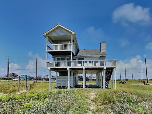 a house with a balcony on the beach at Whispering Sands Beachfront in Galveston