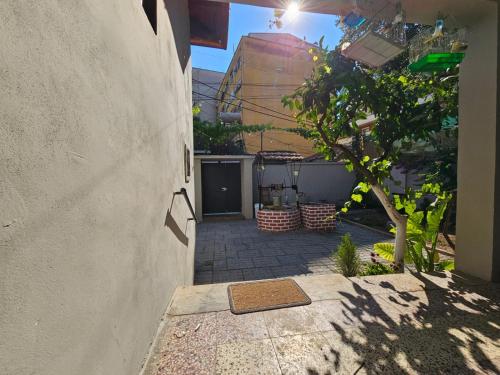 a small courtyard with a tree and a building at Lemon House in Tirana