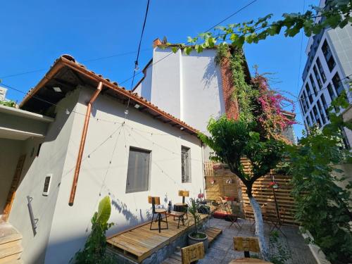 a house with a wooden deck in front of it at Lemon House in Tirana