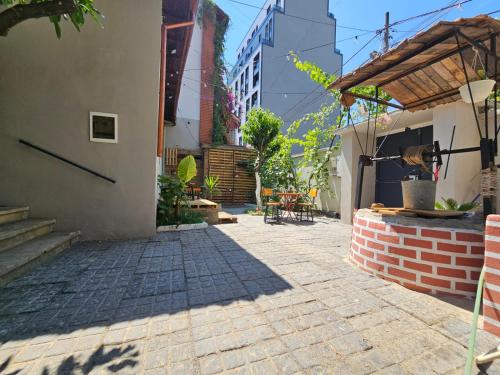 a courtyard of a house with a brick sidewalk at Lemon House in Tirana