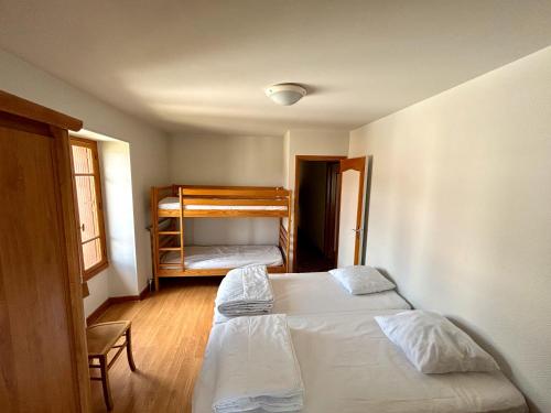 a bedroom with two beds and a bunk bed at Maison De Caractere- Puy De Dome in Pontgibaud