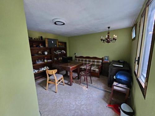 a living room with a table and chairs and a desk at Lemon House in Tirana