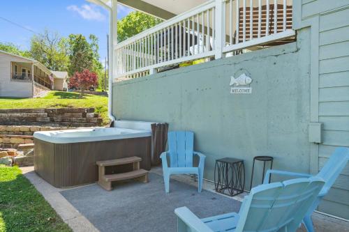 a patio with two chairs and a bath tub at Branson Downtown Beauty - 4 BDR Home Sleeps 15 in Branson