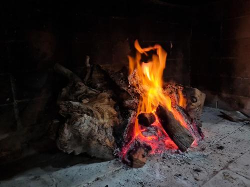 a fire burns in a brick fireplace at La casa de Ailun - Ideal vacaciones in Guaymallen