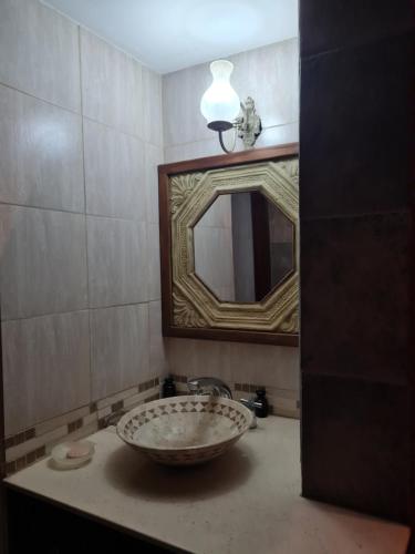 a bathroom with a sink and a mirror at La casa de Ailun - Ideal vacaciones in Guaymallen