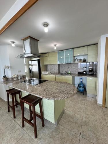 a kitchen with a large island in the middle at Beachfront Apt With Amazing View at Marbella Juan Dolio in Juan Pedro