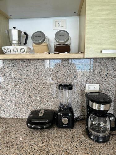 a blender sitting on a counter in a kitchen at Beachfront Apt With Amazing View at Marbella Juan Dolio in Juan Pedro