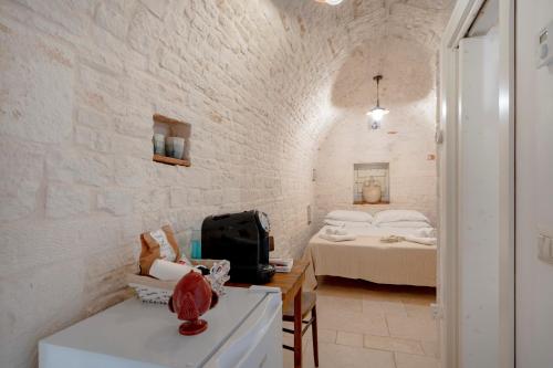Postel nebo postele na pokoji v ubytování Trulli Lithos Suite