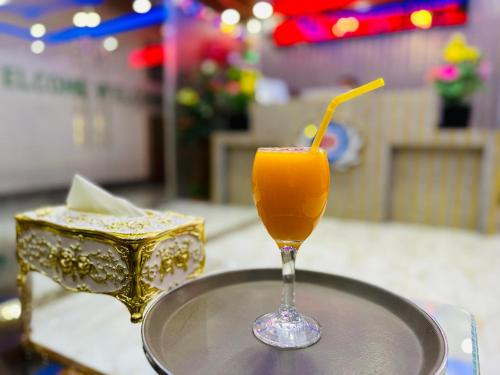 a glass of orange juice sitting on a table at The Ambassador Hotel Dhanmondi in Dhaka