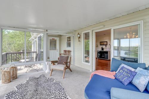 a living room with a blue couch and a balcony at Lake-View Gem with Game Room in Long Pond! in Long Pond