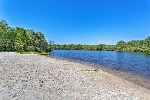 a sandy beach next to a river with trees at Lake-View Gem with Game Room in Long Pond! in Long Pond