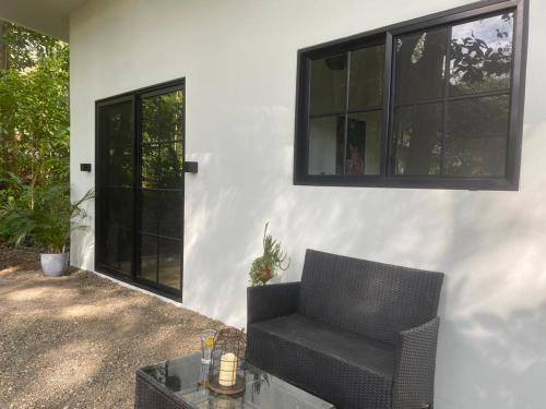 a chair and a table in front of a house at Private Cabina at Yoga Center in Ojochal