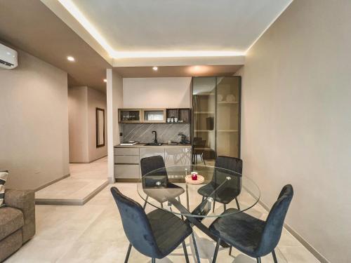 a dining room with a glass table and chairs at AF Apartments in Lecce