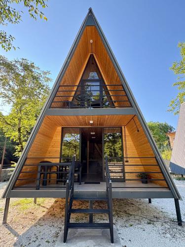 a triangular house with a table and two chairs at Wooden House Martvili in Martvili