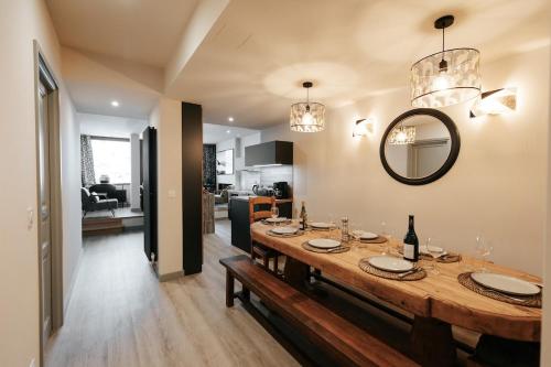 a dining room with a table and a mirror at Alpaka Mountain Lodge - The Perfect Summer Holiday in Tignes