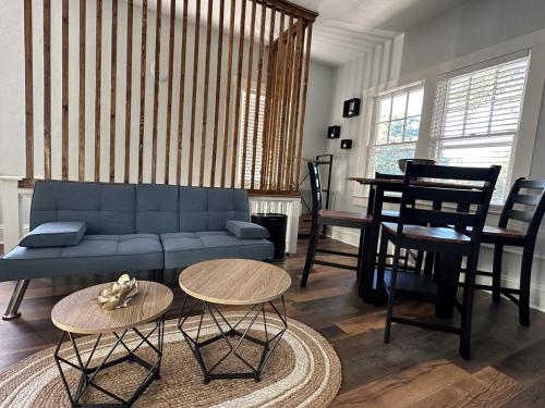 a living room with a blue couch and tables at Deland Serenity Place #2 in DeLand