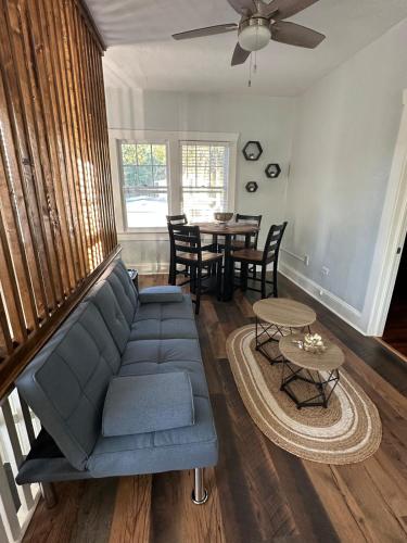 a living room with a blue couch and a table at Deland Serenity Place #2 in DeLand