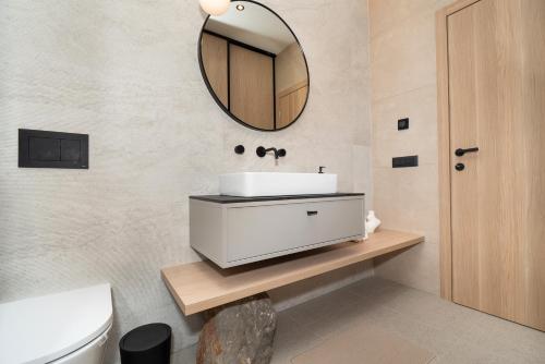 a bathroom with a sink and a mirror on the wall at Villa Lapidea in Vodice