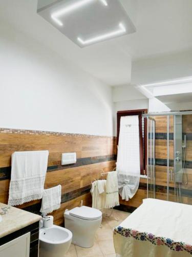 a bathroom with a toilet and a sink at B&B by Family L&G in Vibo Valentia Marina