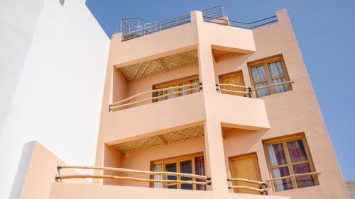 a building with balconies on the side of it at Tasga Guest House in Tamraght Oufella