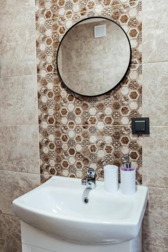 a bathroom with a sink and a mirror at Hrisi&Kris in Sapareva Banya