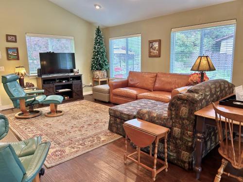 a living room with a couch and a christmas tree at Bigfork Lake Getaway in Bigfork