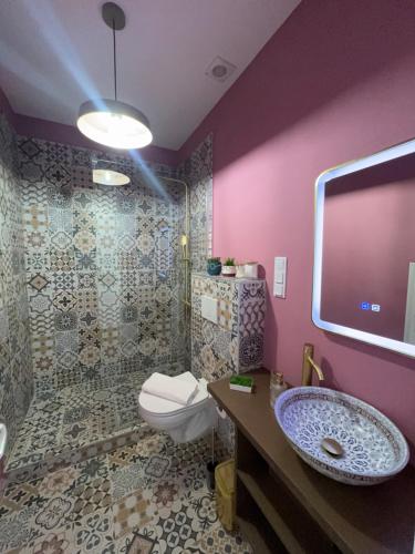 a purple bathroom with a toilet and a sink at FLH - Central Oasis in Sibiu