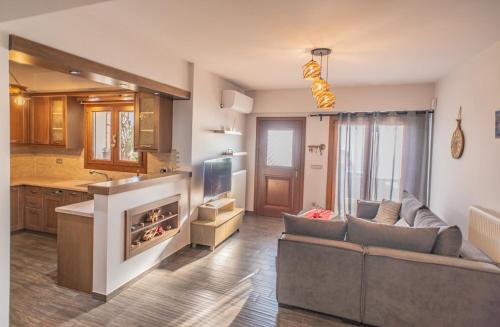 a large living room with a couch and a tv at Sea Sun House, Aprovato Andros in Apróvaton