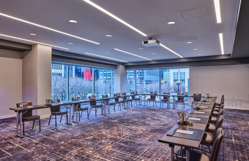 a conference room with tables and chairs and windows at Loews Chicago Hotel in Chicago