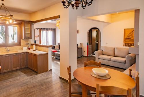 a kitchen and a living room with a table in a room at Sea Sun House, Aprovato Andros in Apróvaton