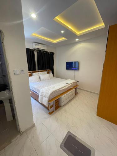 a bedroom with a bed and a television in it at 2 bedroom terrace in Lekki