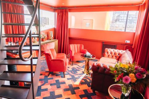 a living room with red walls and a staircase at Botel in Amsterdam