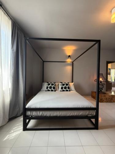 a bedroom with a canopy bed in a room at JR HOME Apuania in Massa