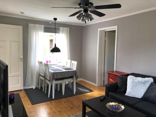 a living room with a table and a couch at Entire cabin - Mora, Selja, cabin in village environment for 4 persons in Mora